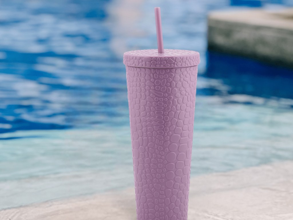 purple tumbler in front of a water