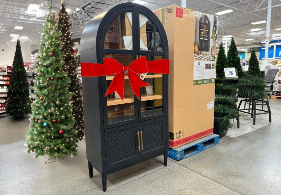 sam's club store with black arched cabinet with big red bow