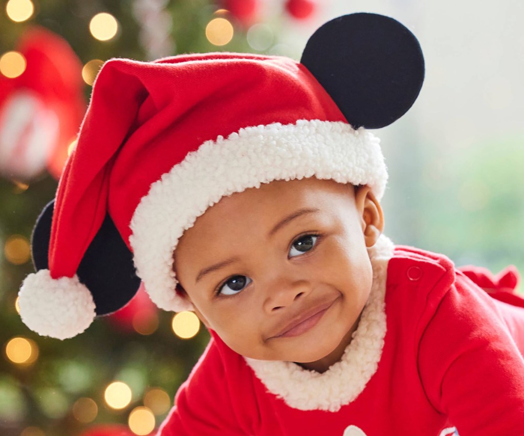 baby wearing santa hat with mickey ears