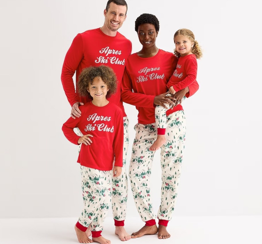 family of 4 wearing matching ski club family pjs