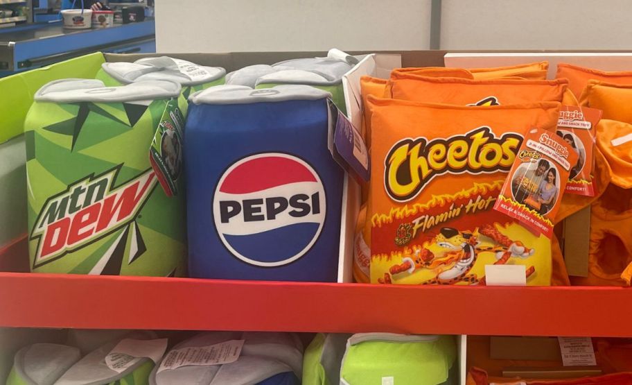 mountain dew, pepsi, and flaming hot cheetos snack tray pillows on display in a walmart store