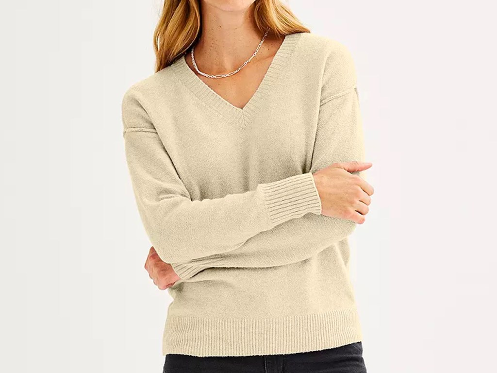 woman wearing beige sweater