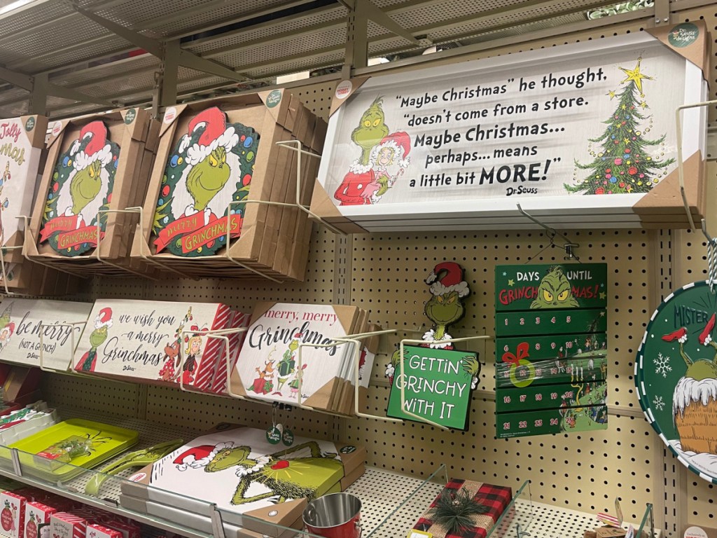 store display of grinch signs and hanging items