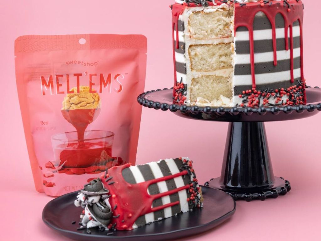 Sweetshop red meltems next to a cake 