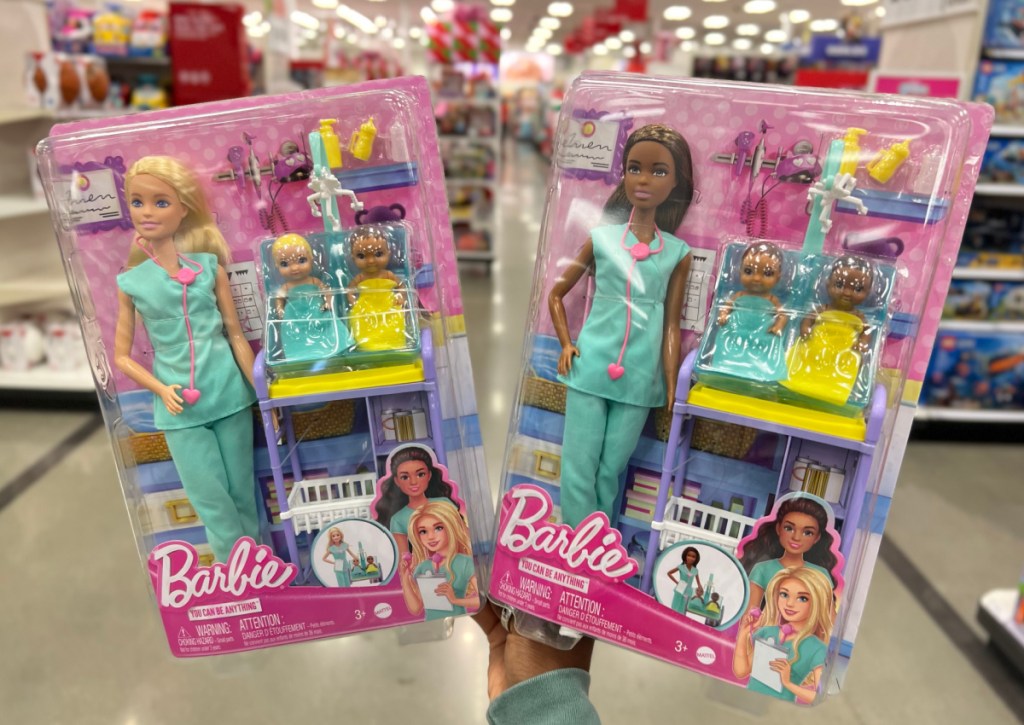 two doctor barbie sets in hand at target