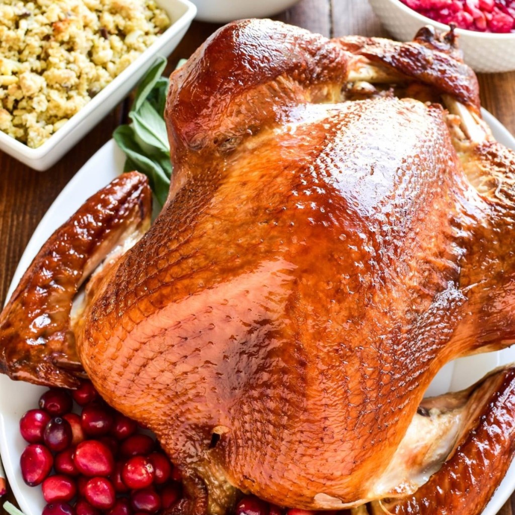 turkey on table with Thanksgiving side dishes