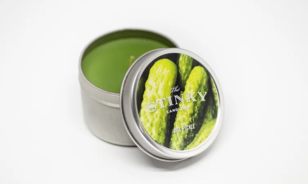 tin containing small green candle