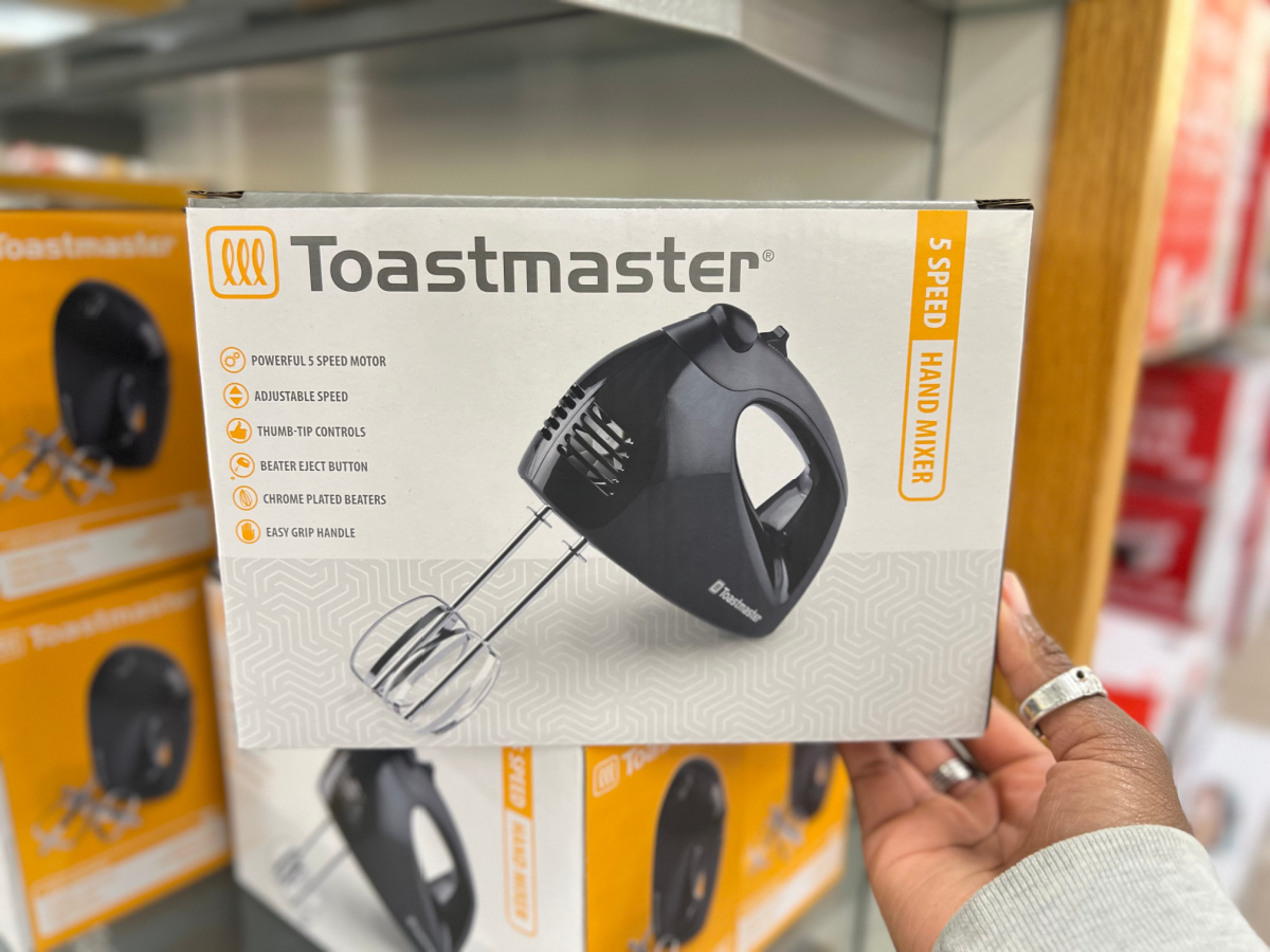 hand touching a toastmaster hand mixer box on a kohls store shelf