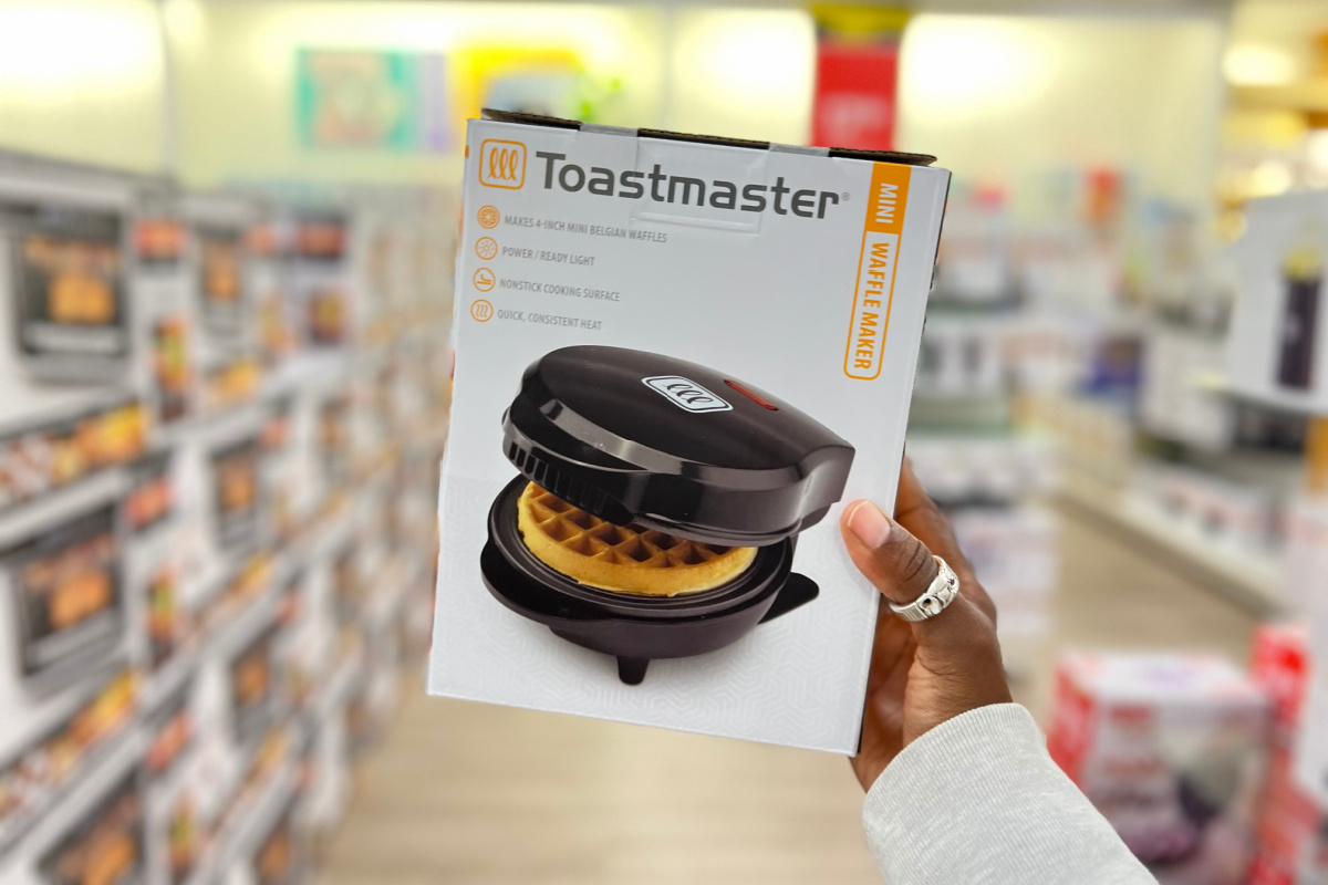 hand holding a toastmaster waffle maker box in the middle of a kohls aisle