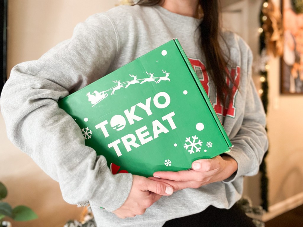 woman holding a tokyo treat box under the arm