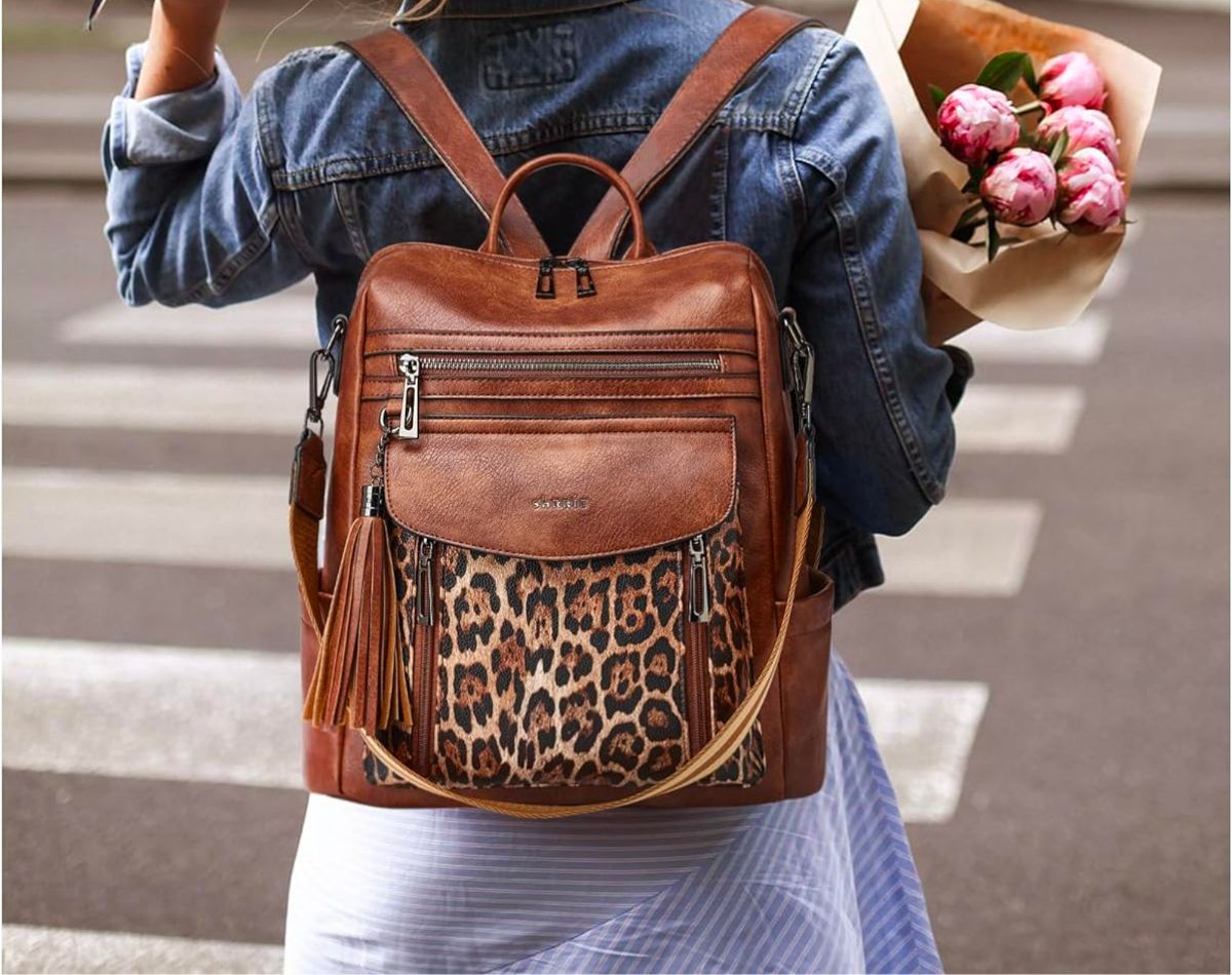 woman wearing a brown and leopard print travel pack pack