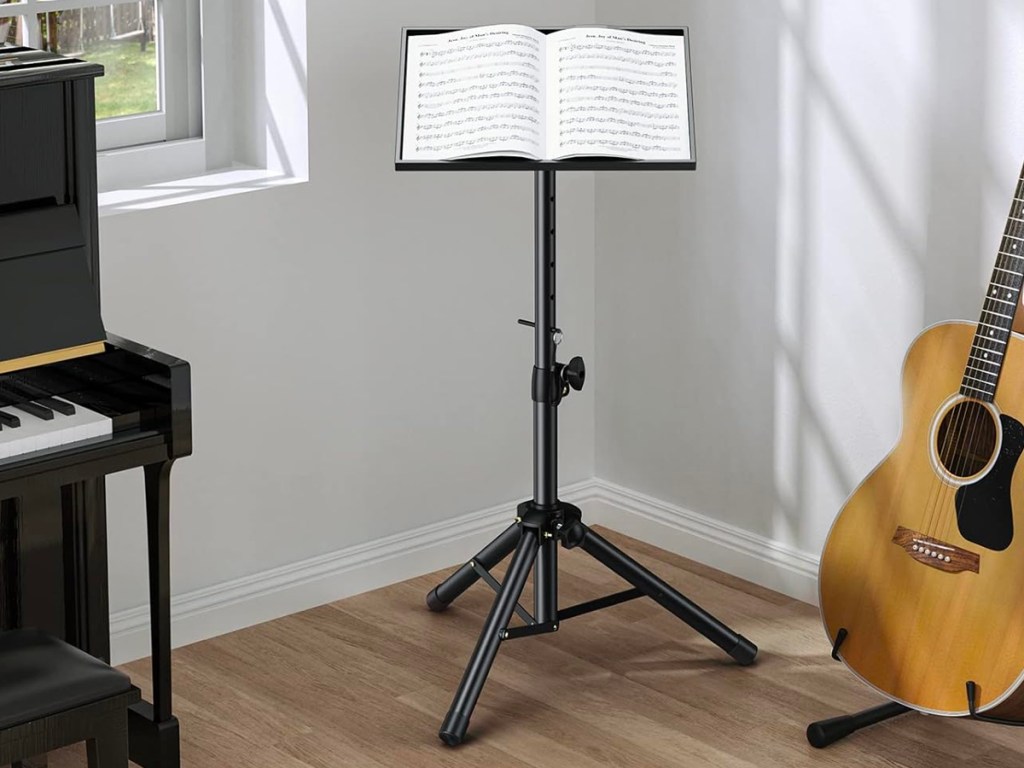 black tripod with music book on top