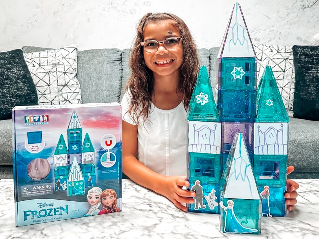 girl playing with tytan tiles frozen set and box