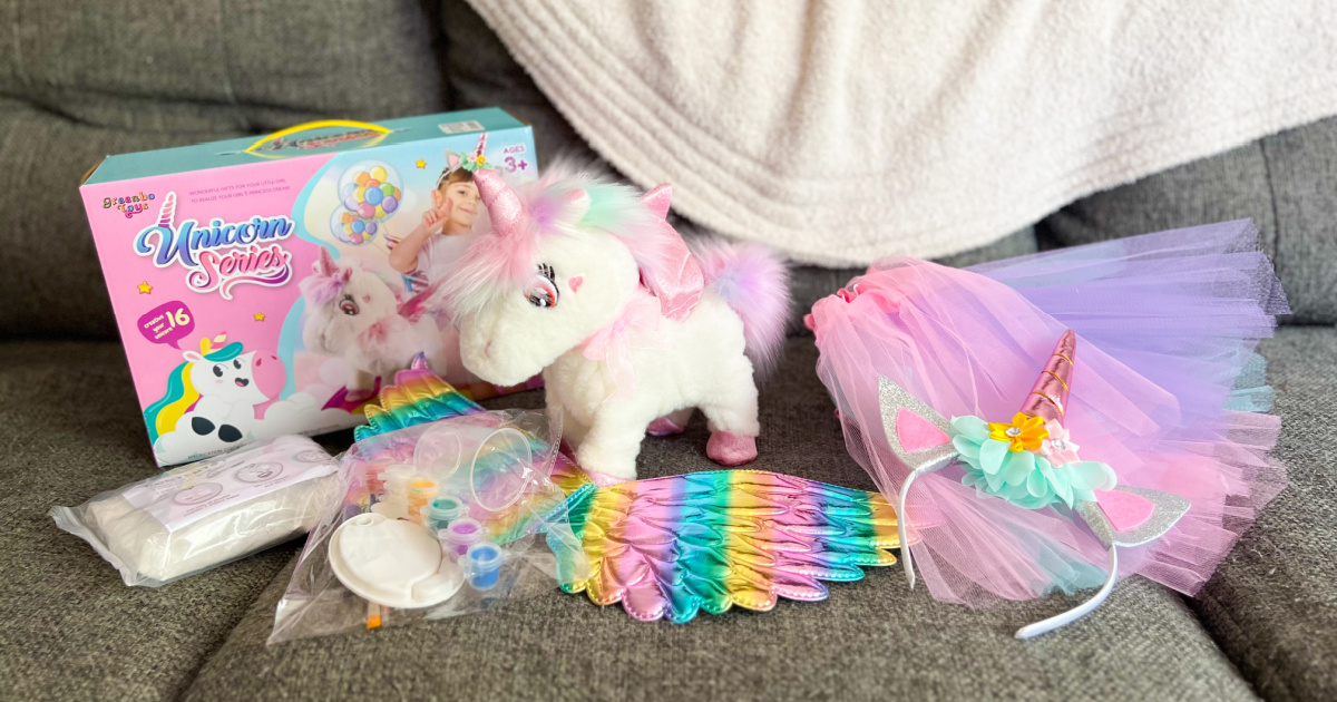 plush unicorn toy and accessories displayed on a couch