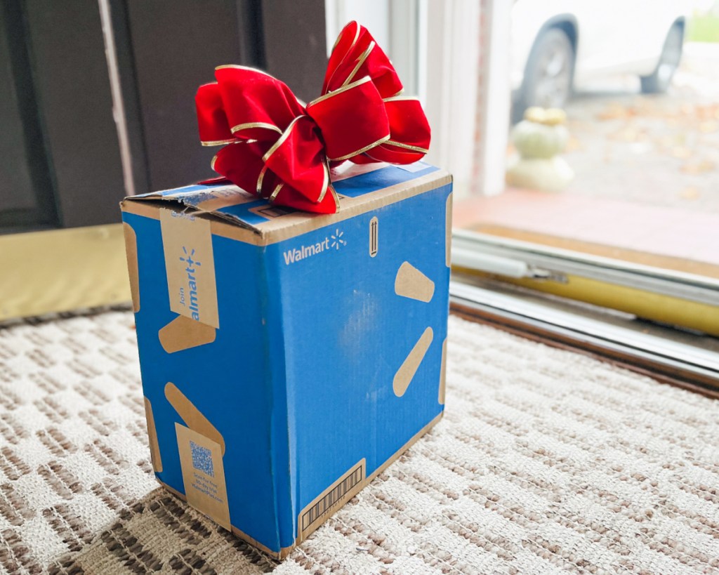 walmart box with red bow at the front door