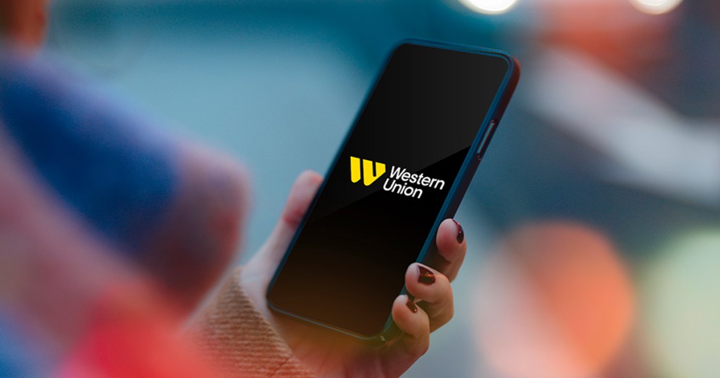 hand holding phone with western union app open