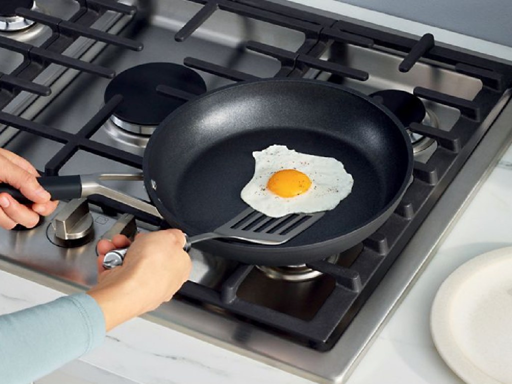 woman cooking an egg on ninja cookware