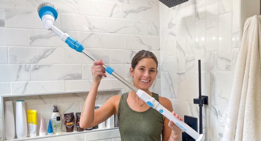 woman holding bathroom cleaning spin brush in the bathroom