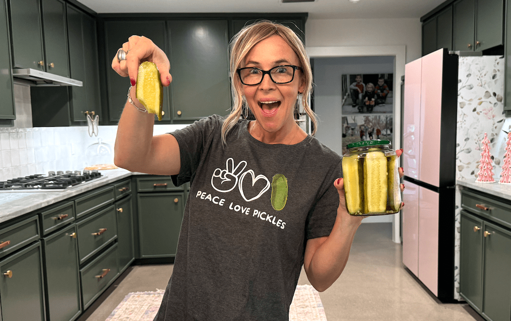 woman holding pickle jar wearing pickle shirt 