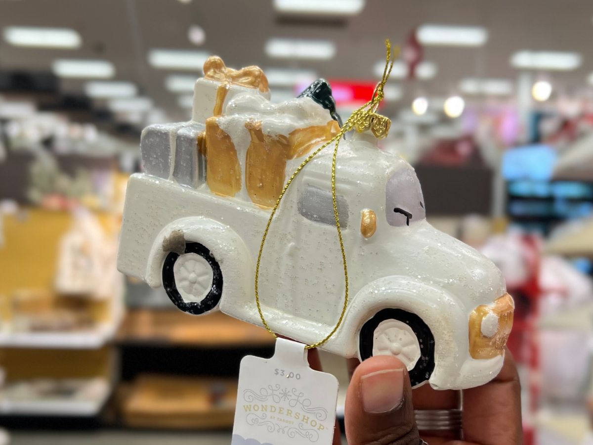 a womans hand displaying a wondershop vintage truck ornament