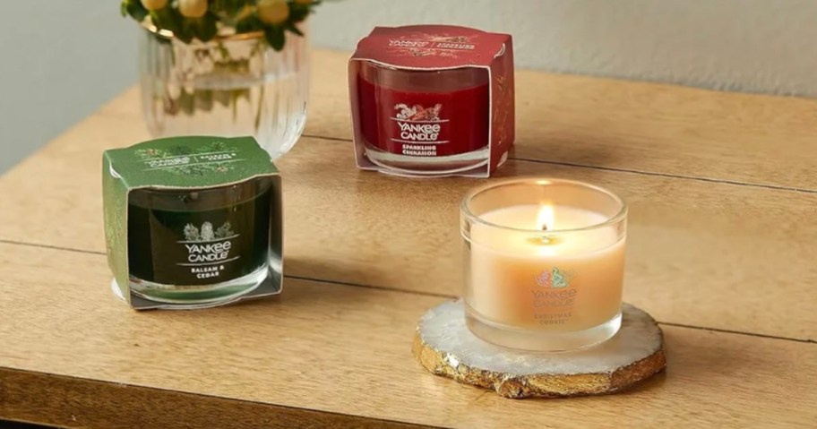 three single mini candles on table