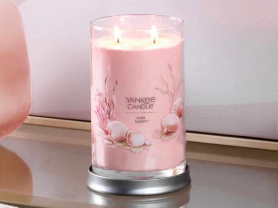 pink sands large candle on table