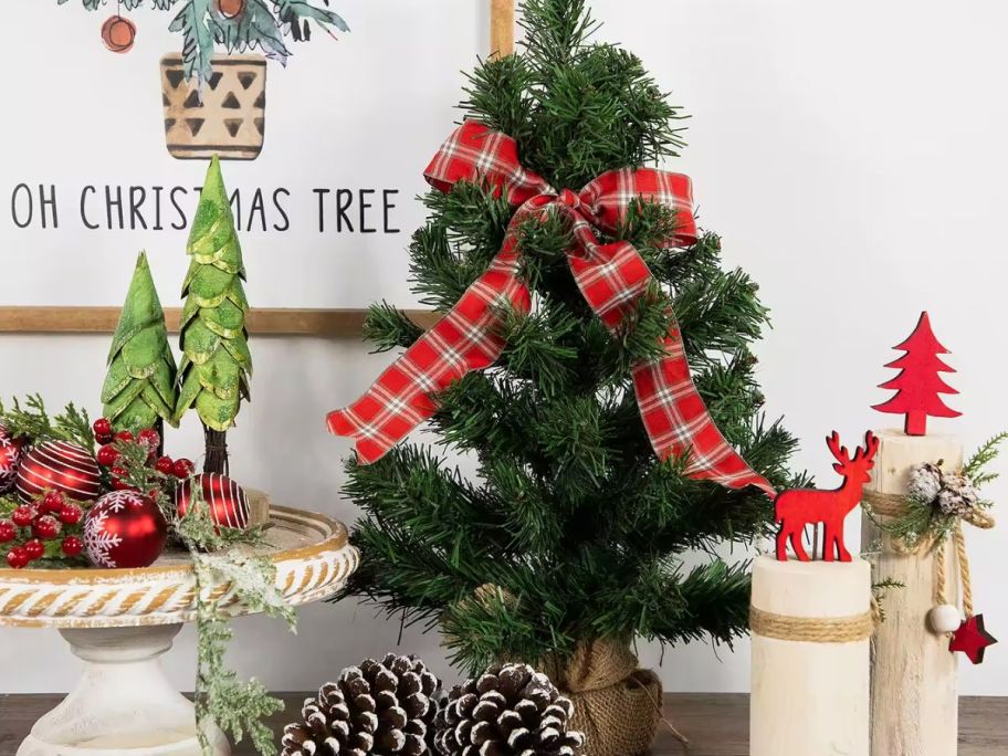 small Christmas tree on counter with other Christmas decor