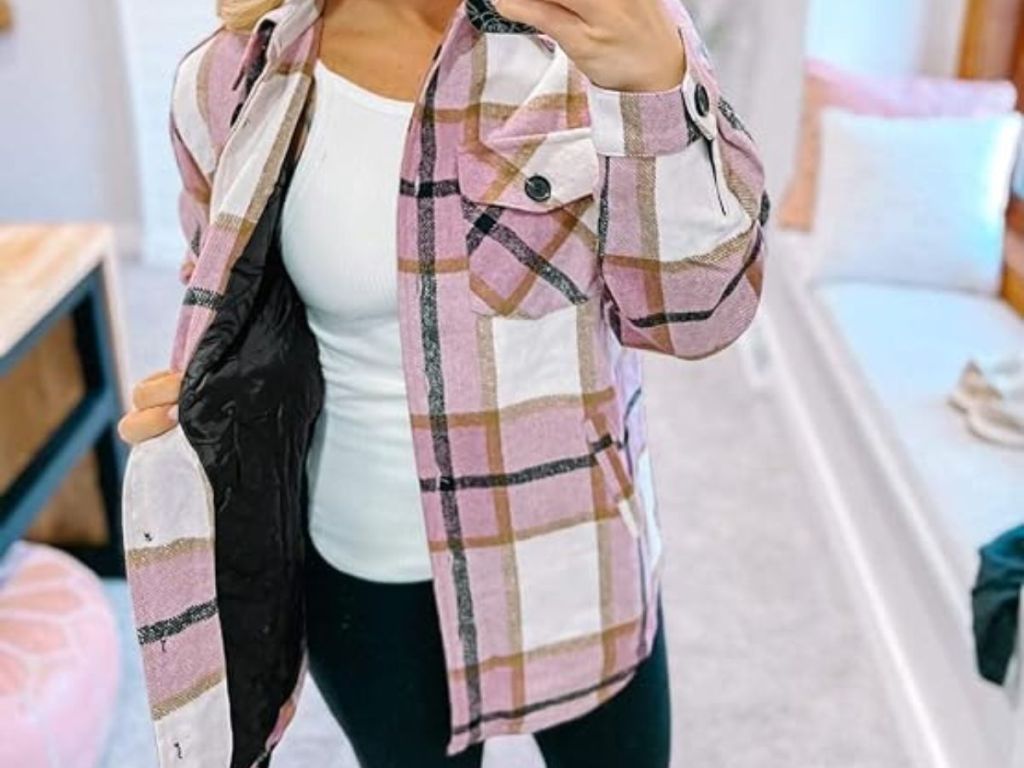 woman wearing a pink white multi color plaid shacket