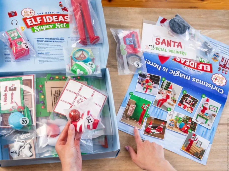 person pulling items out of an Elf on the Shelf Elf Ideas Super Set