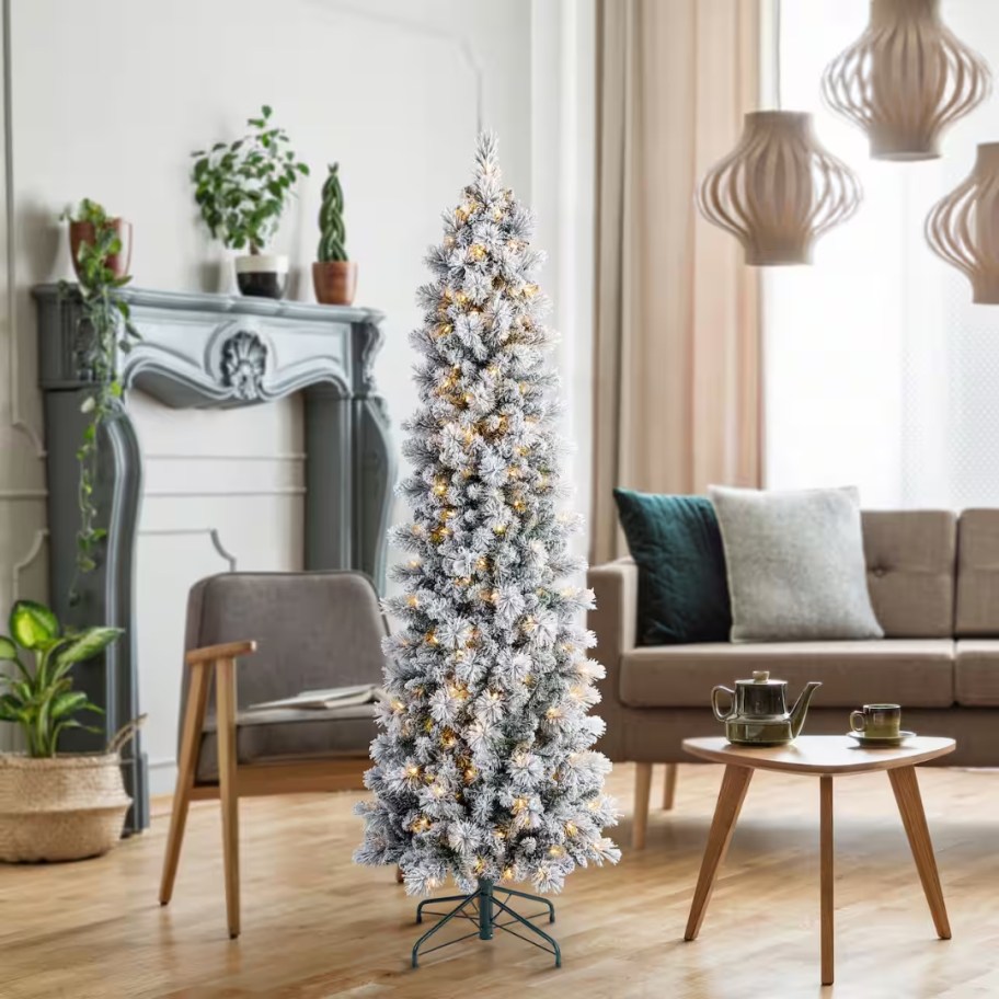 a 6 foot flocked slim pencil artificial Christmas tree in a living room