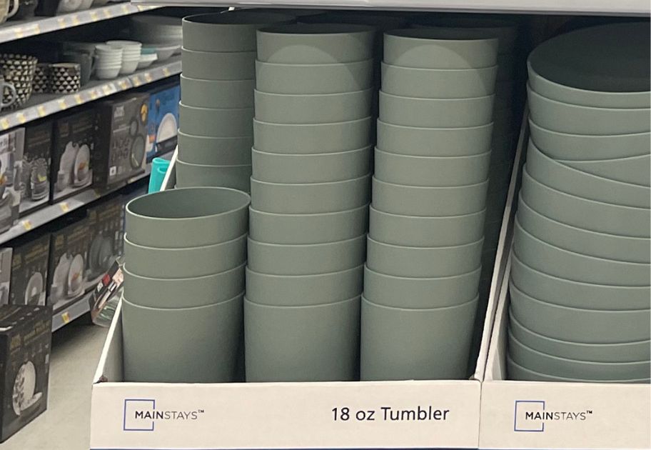 stacks of Mainstays 18-Ounce Round Plastic Tumblers on shelf at Walmart