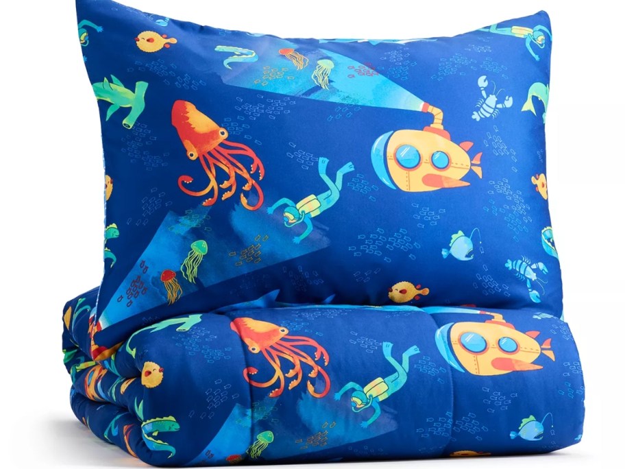 blue comforter and sham with ocean animals and scenery on it