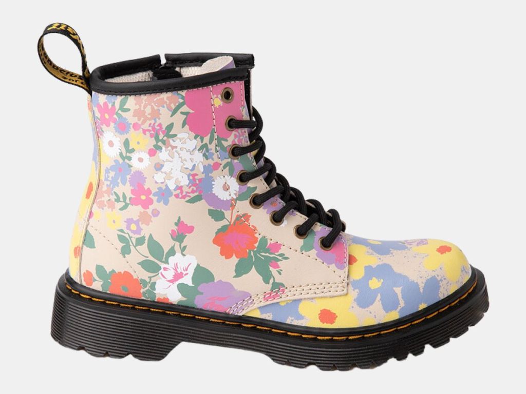 single Dr. Marten's girls lace up boot with tan background and flowers