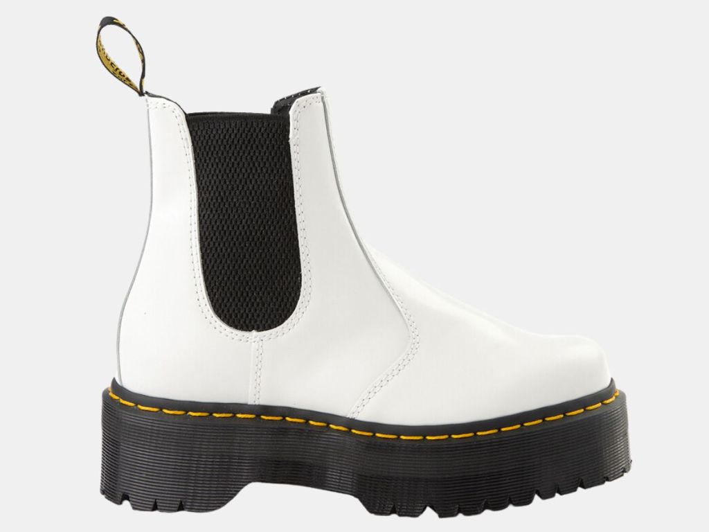 single white chunky slide on Dr. Marten's boot with black accents and sole