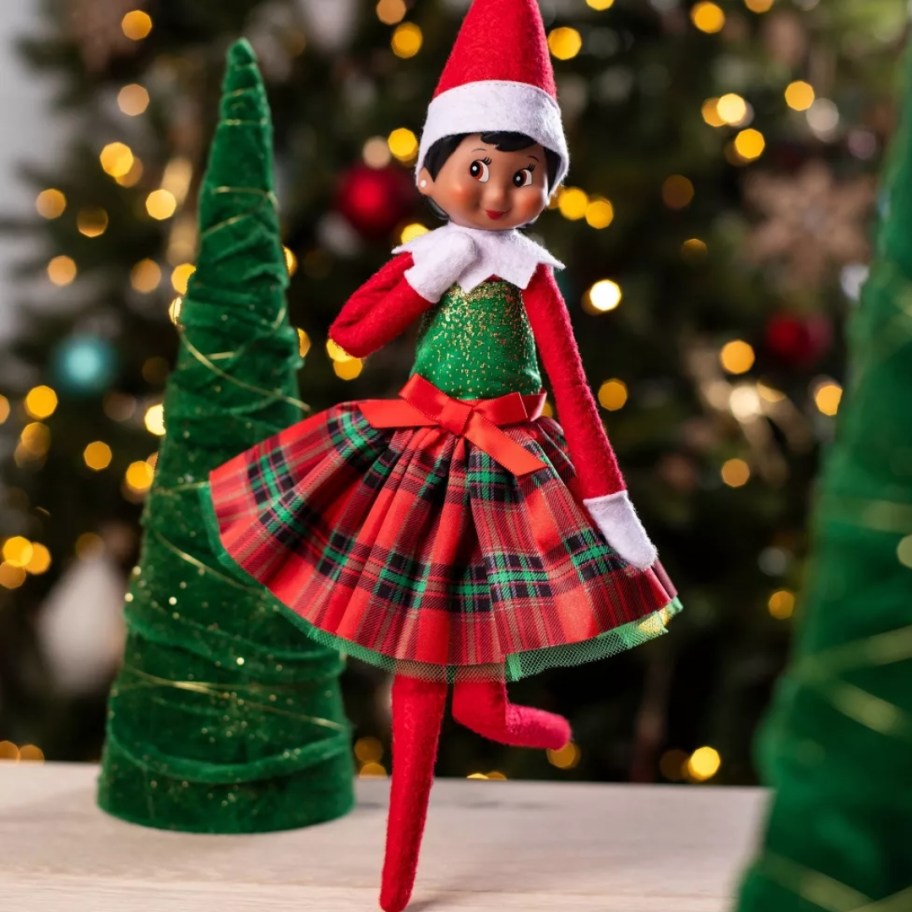 girl Elf on The Shelf doll in a red and green plaid holiday dress