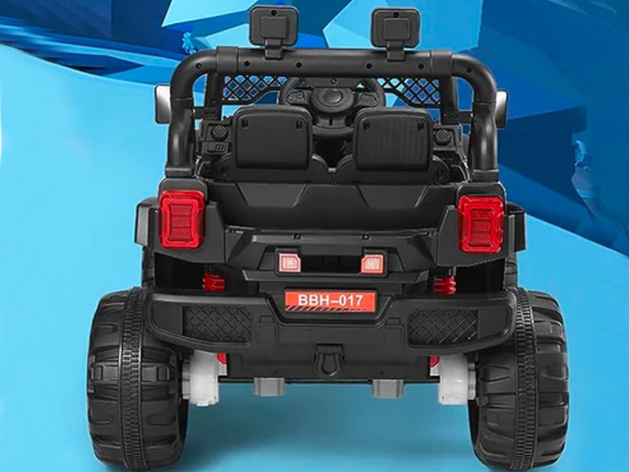 back of jeep lookalike electric black car on blue background