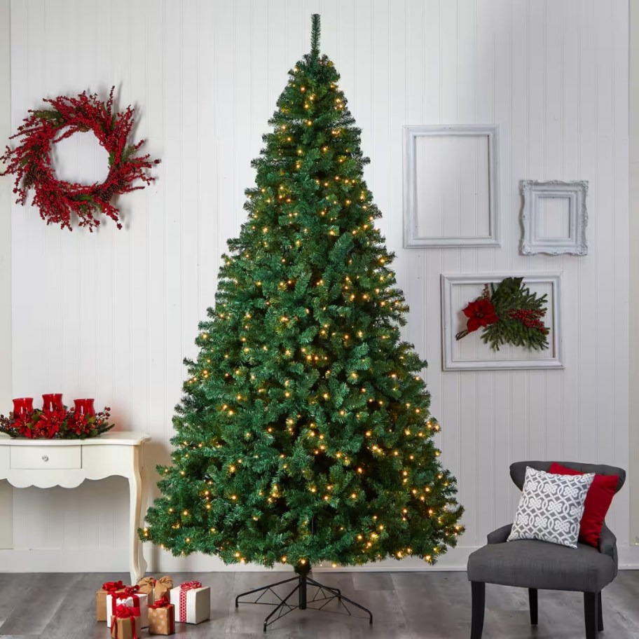 large green artificial christmas tree with clear lights in a living room