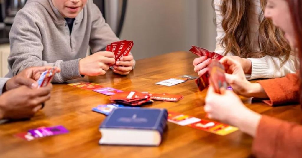 teenagers around a table playing Organ Attack Card game