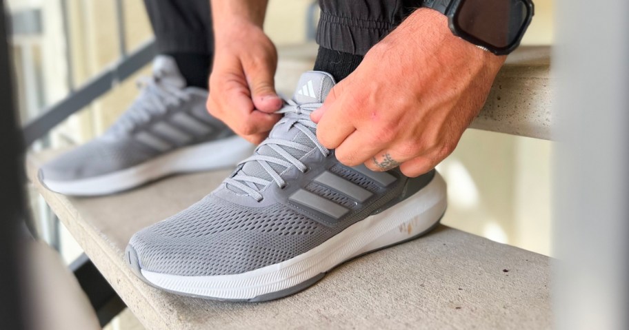 man wearing adidas men's ultrabounce shoes in gray