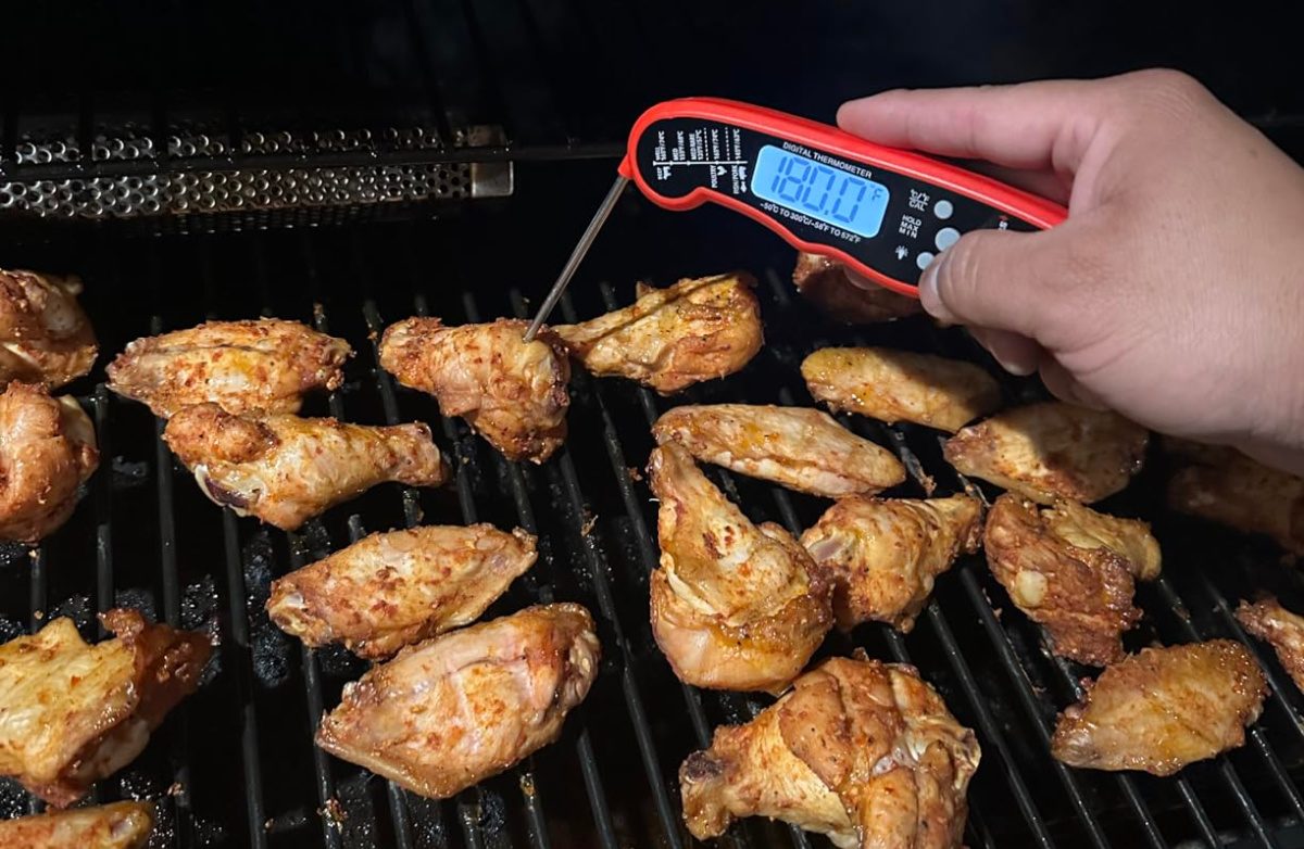Person using an Alpha Grillers Meat Thermometer to check the temperature of their chicken