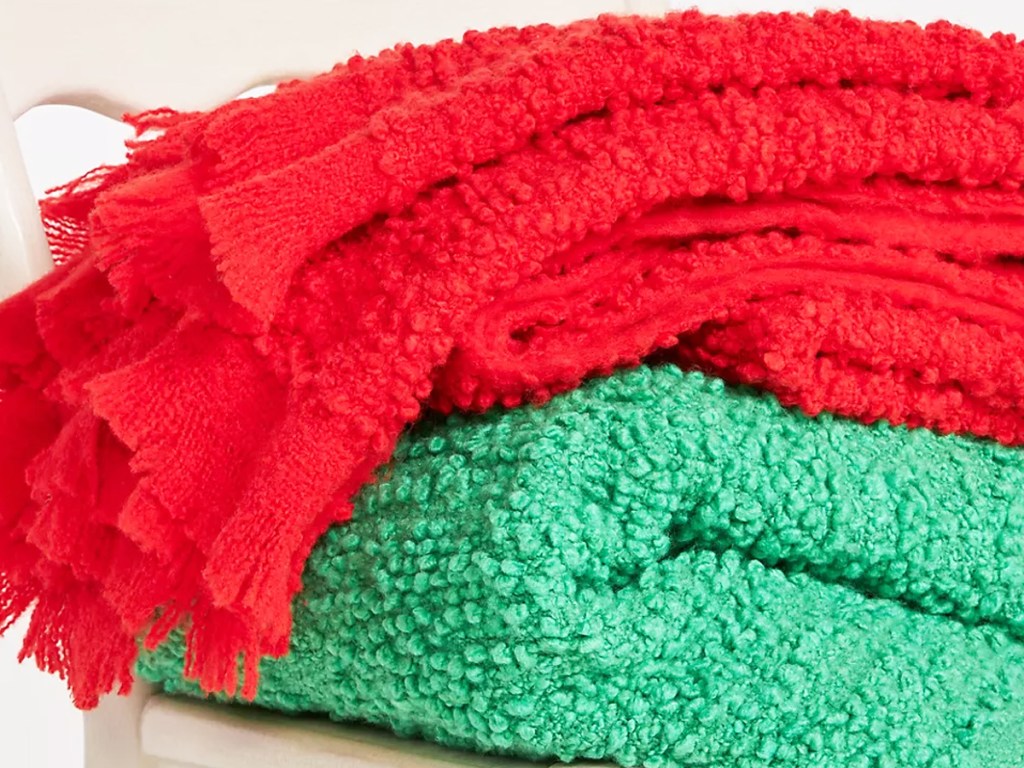 folded red and green throw blankets