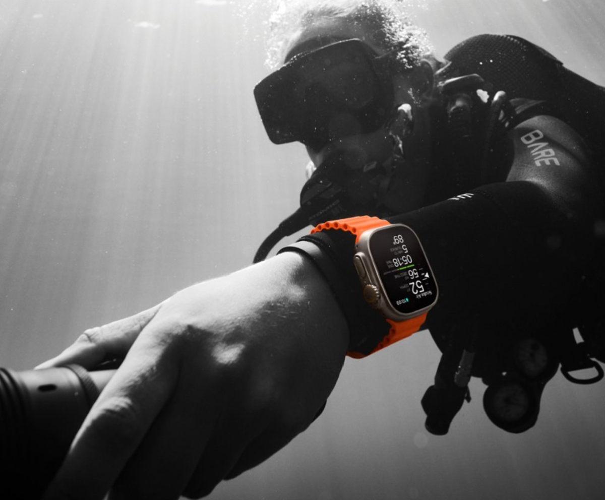 Man using an Apple Watch Ultra 2 underwater