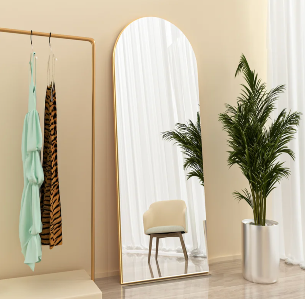 one of our favorite last minute Wayfair gifts, an arch metal mirror from Red Barrel Studios propped up against the wall