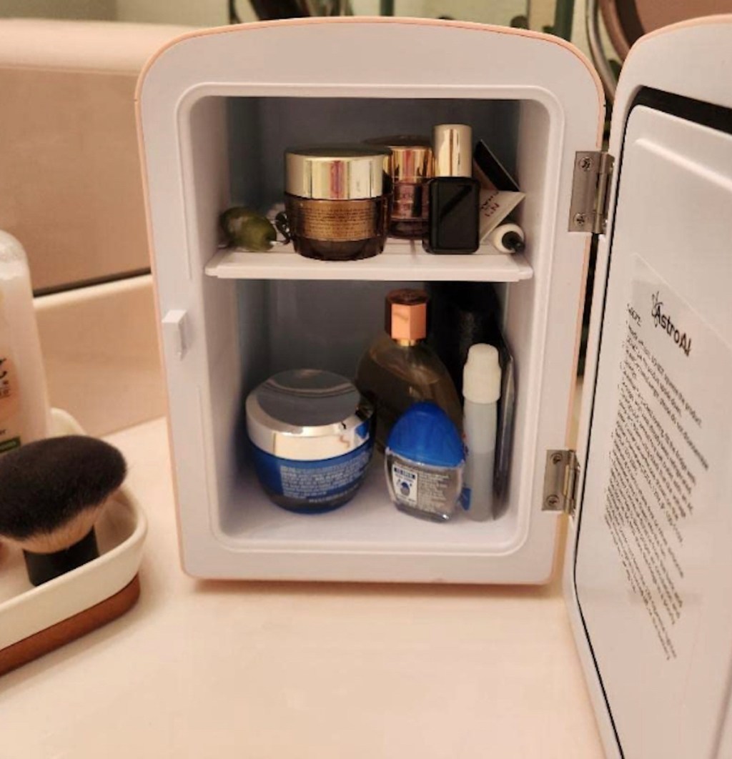 close up of mini fridge with beauty products inside