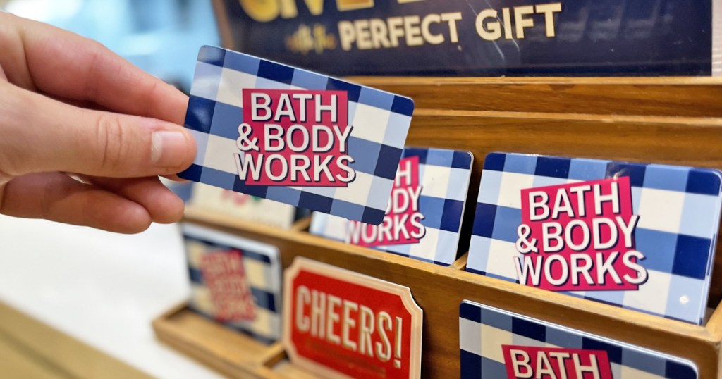 hand holding a bath & body works gift card