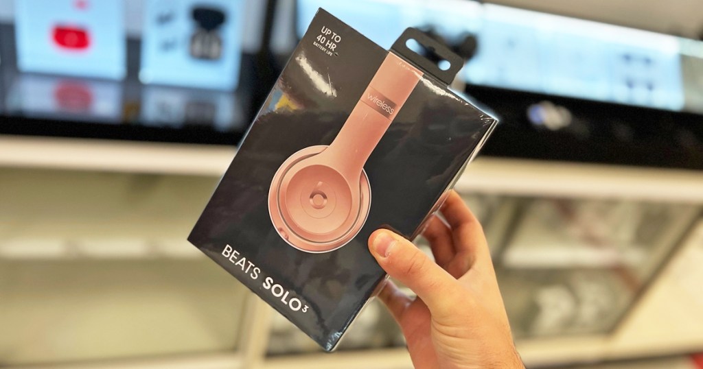 hand holding up a box for rose gold Beats Solo 3 Wireless Headphones