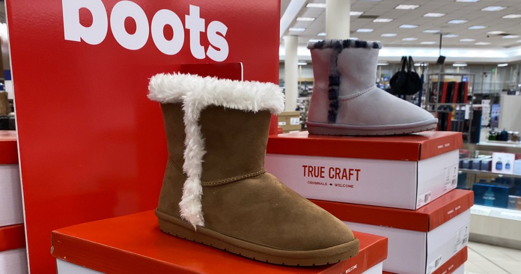 fuzzy boots on top of shoe boxes in store