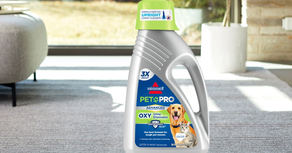 bottle of Bissell Pet Urine Stain & Odor Remover on carpet in living room