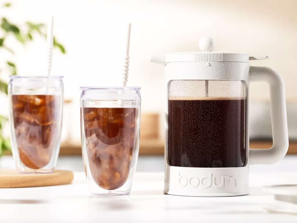 white french press with two cups of iced coffee