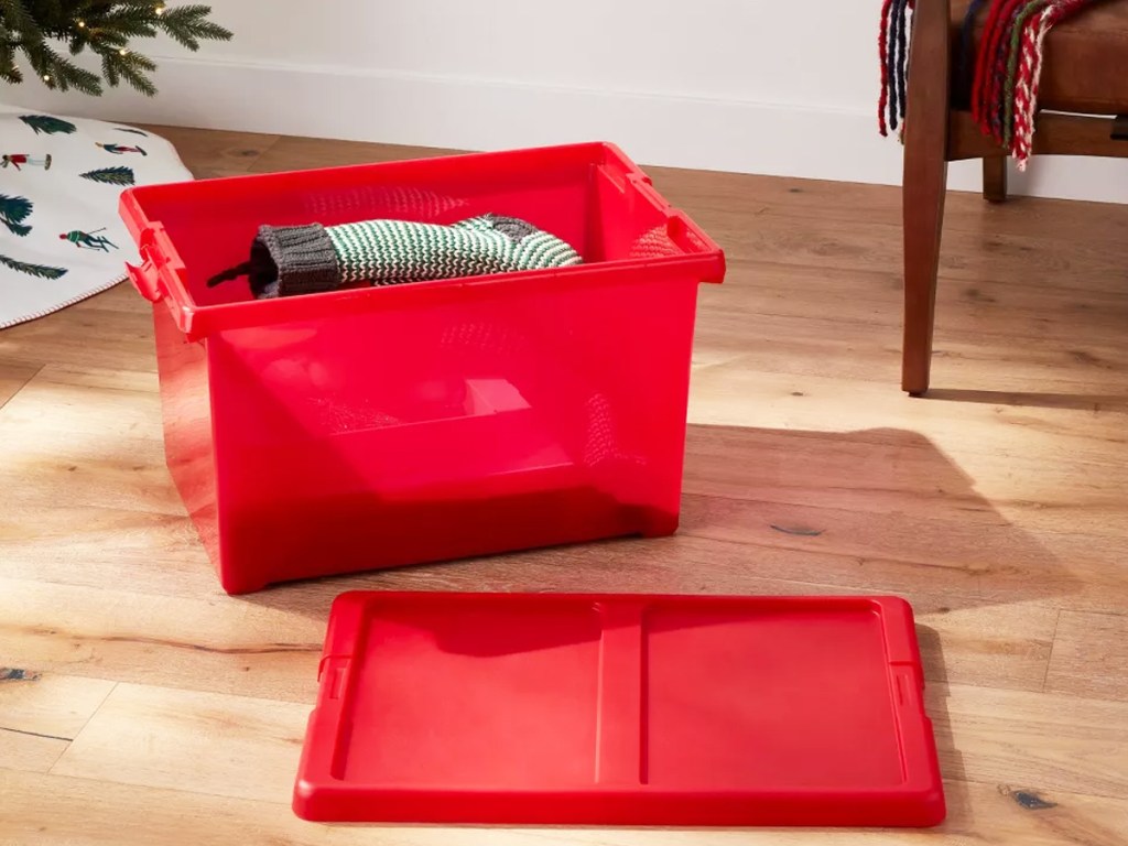 red storage box with sweaters inside
